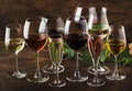 Wine tasting, still and sparkling wines. Red, white wine, rose and champagne ÃËÃâ assortment in wine glasses on vintage wooden